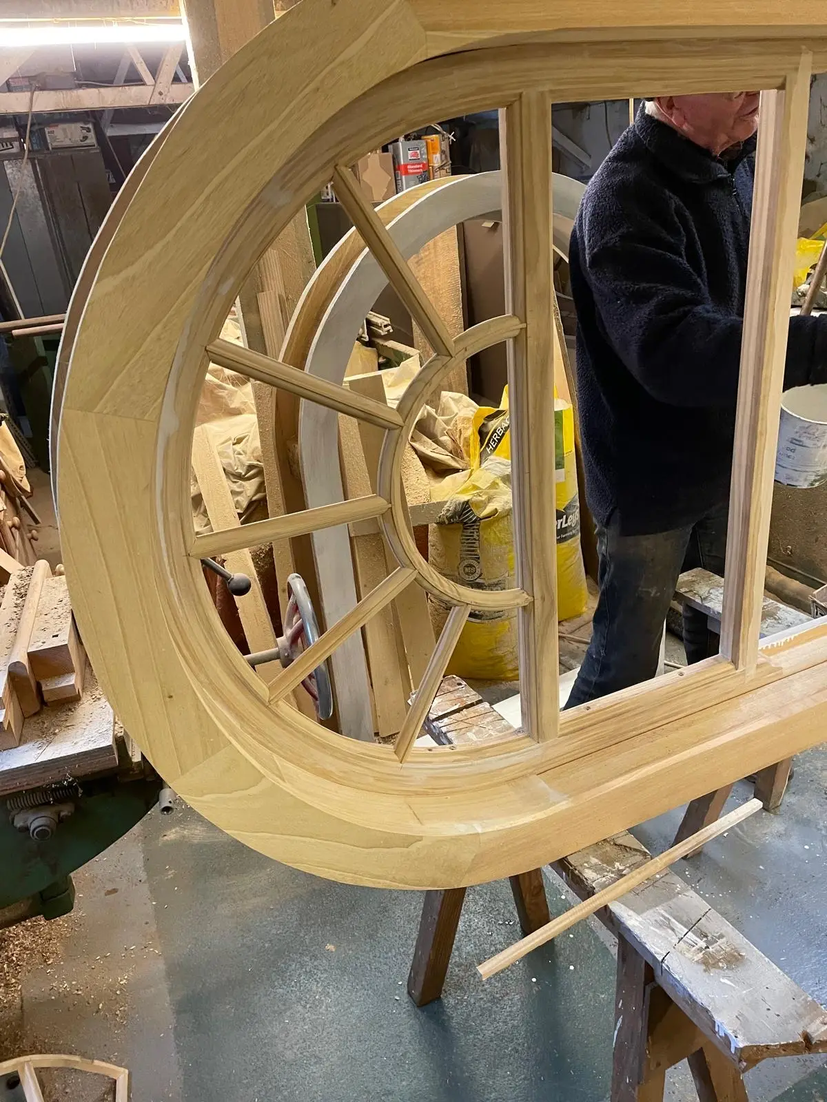 Large circular timber window with radial glazing bars, built in the workshop