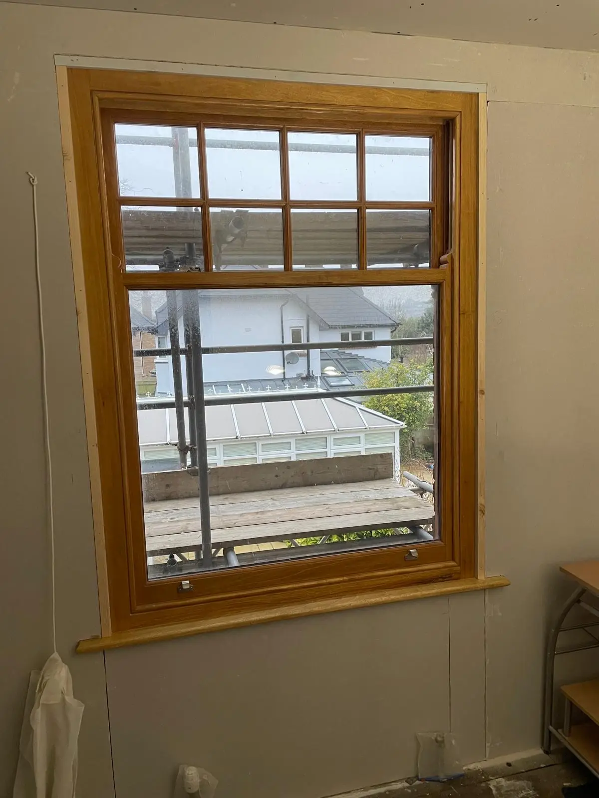 Varnished oak sash window with multi-pane upper light, interior view