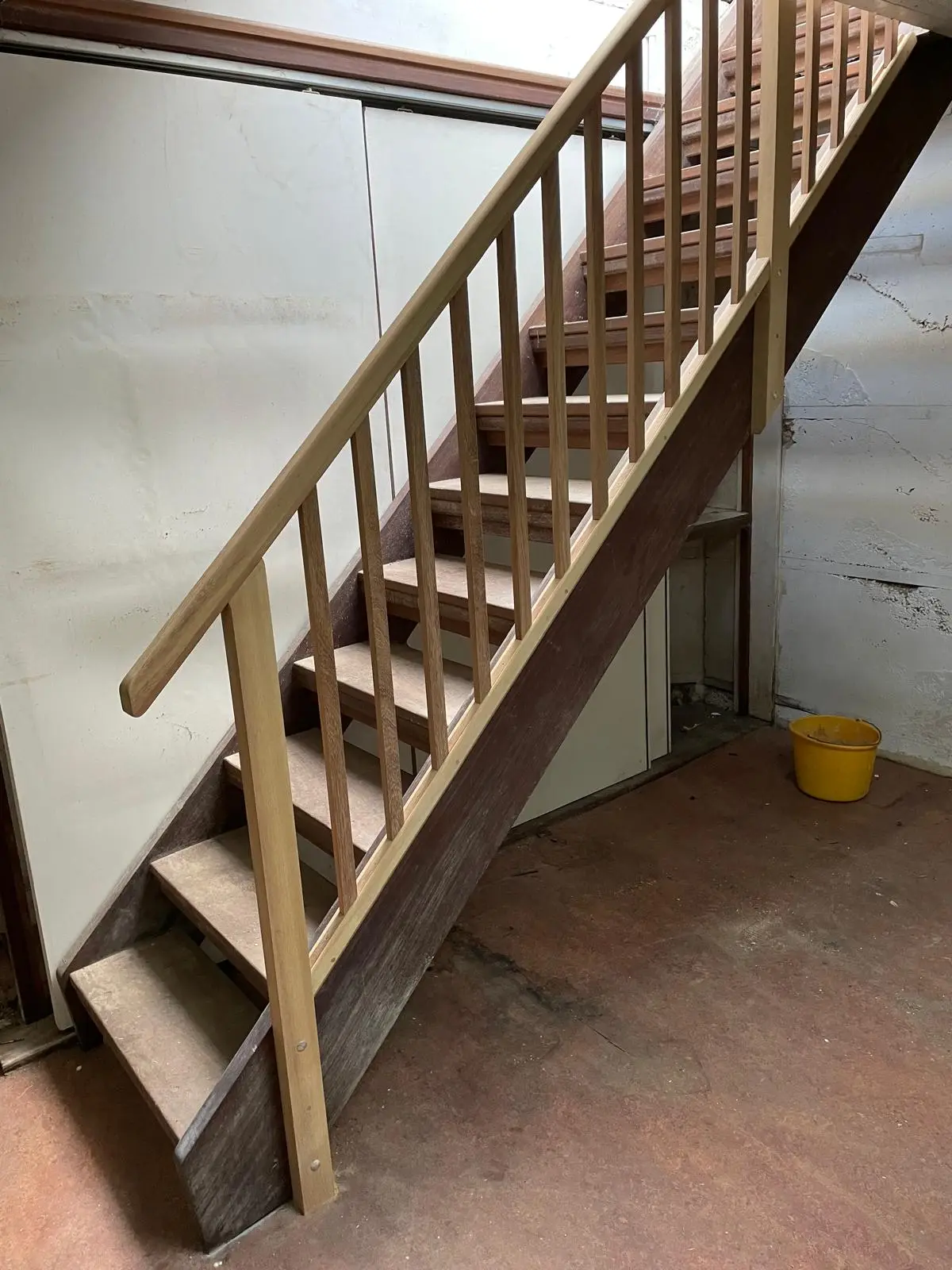 Hardwood staircase with a slatted timber balustrade and handrail, built as a single unit